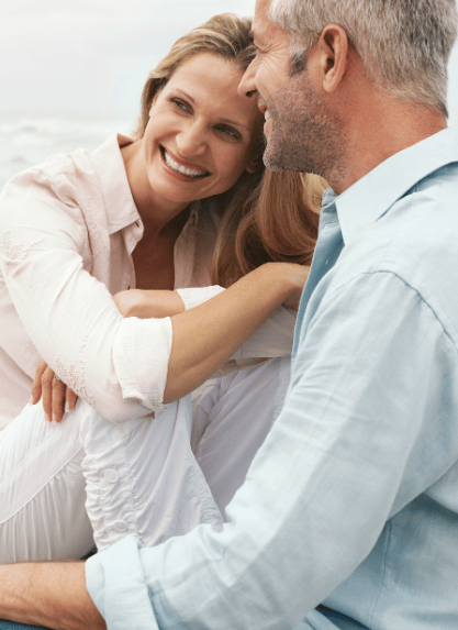 man and woman relaxing at the beach